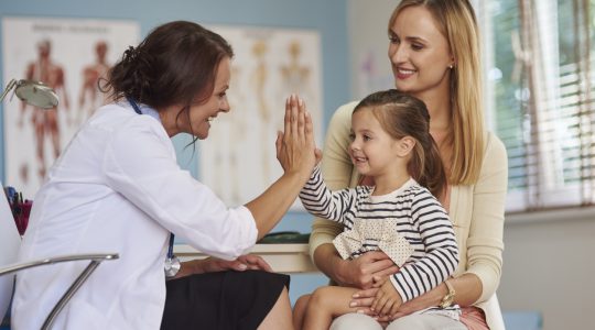 Woman doctor visiting child and mother