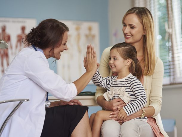 Woman doctor visiting child and mother